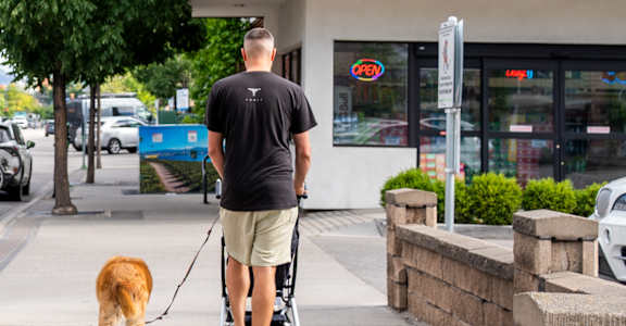 A man walking his dog in front of Lakeview Market.