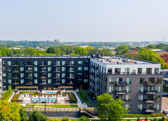 an aerial view of a large building with a pool in front of it at The Mason, St. Paul, 55114