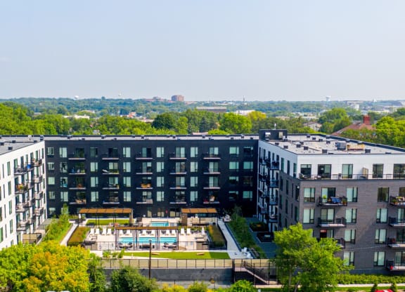 an aerial view of a large building with a pool in front of it at The Mason, St. Paul, 55114