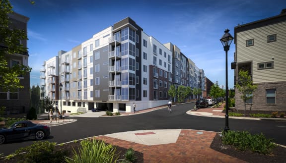 a rendering of a grey and white apartment building on a street corner at East 51 At Rocketts Landing, Richmond, 23231