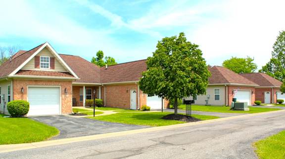 A house with a tree in front of it.