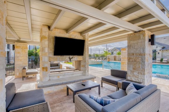 a living room with a fireplace and a television at Citadel at Westpointe, Texas