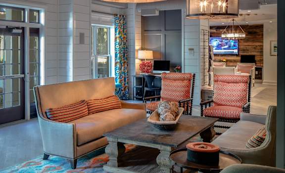 a living room filled with furniture and a large chandelier at The Standard, South Carolina