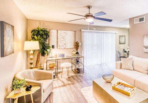 living room view with a couch and fan at Hillside Creek in Austin, TX