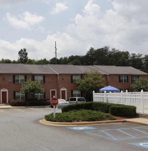 an apartment building with a parking lot in front of it  at Brookside Pointe, Travelers Rest, SC 29690