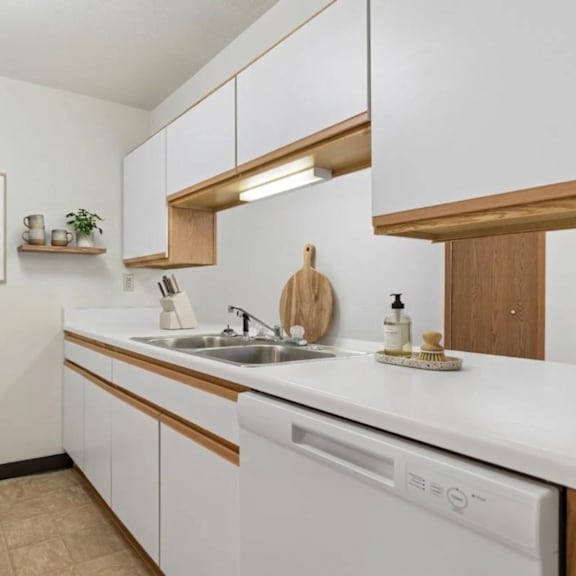 A kitchen with white appliances and wooden accents.