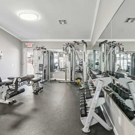 Fitness center with free weights and cable weight machines at Riverwood Crossing apartments in Roswell, GA.