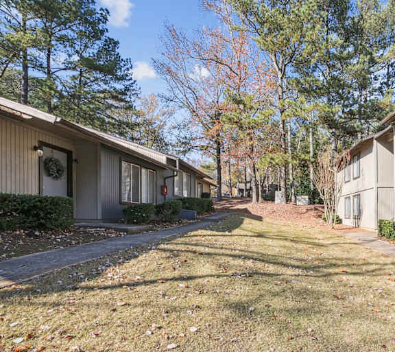 Lush landscaping in the beautiful autumn season at Riverwood Crossing apartments in Roswell, GA.