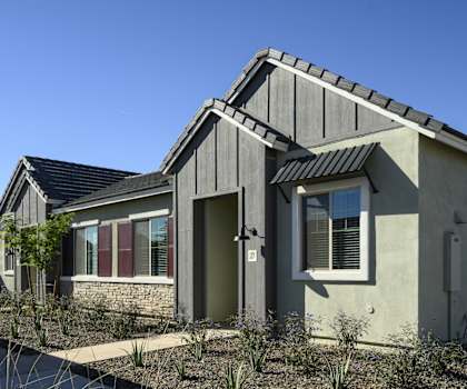 the front of a house with a driveway and a sidewalk at Village of Chandler, Arizona, 85249
