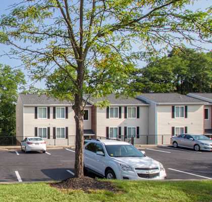 This is a picture of a couple of apartment buildings in a lush wooded setting at Deer Hill Apartments in Cincinnati Ohio.