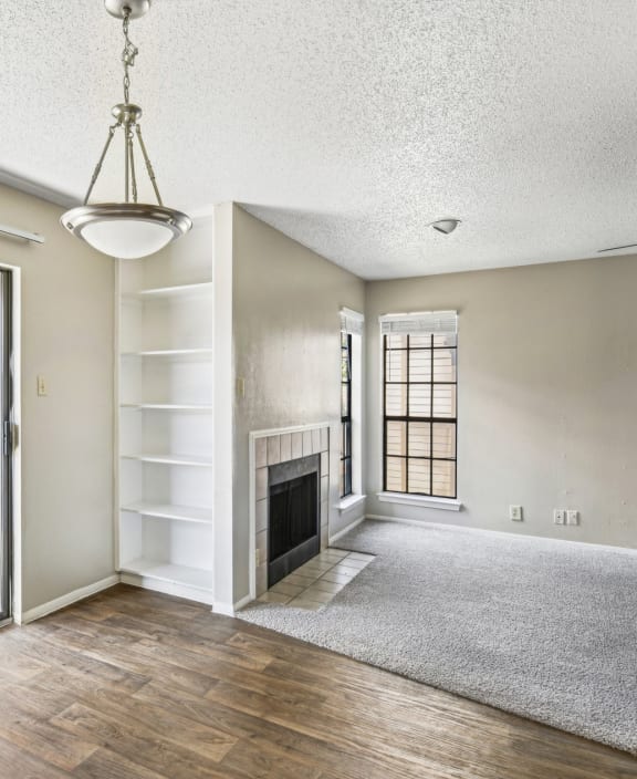 Living room connected to  a private patio with sliding glass door at Bandera Crossing apartments in San Antonio, TX