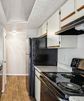 Modern kitchen with black appliances and double basin sink at Bandera Crossing apartments in San Antonio, TX