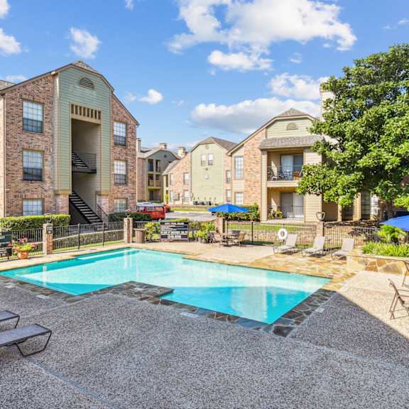 Spacious living room with large windows at Bandera Crossing apartments in San Antonio, TX
