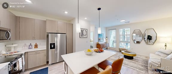 A modern kitchen with a dining table and chairs.
