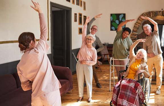 A group of people dancing in a room. at Heron Pond 55+ Apartments, Lehigh Acres, FL, 33972