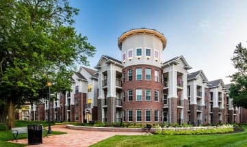 a large building with a round tower on top of it at Canopy at Ginter Park Apartments, Richmond, VA, 23227