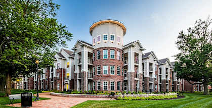 a large building with a round tower on top of it at Canopy at Ginter Park Apartments, Richmond, VA, 23227