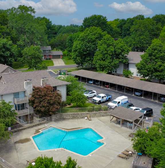 a aerial view of a swimming pool in front of a house