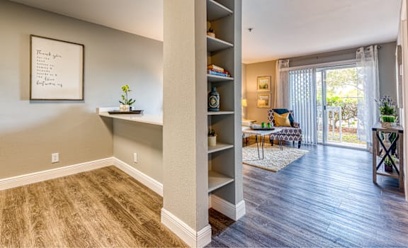 an open living room and dining room with a sliding glass door