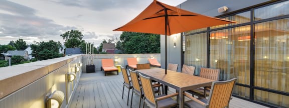 Community roof deck with dining seating and lounge seating