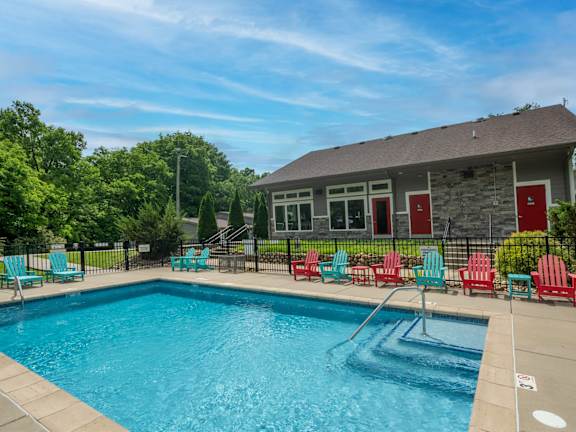 The Retreat at Indian Lake swimming pool with blue and red chairs