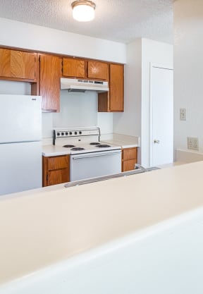 Unit Kitchen with White Appliances at Heritage Square Apartments in Waco, TX