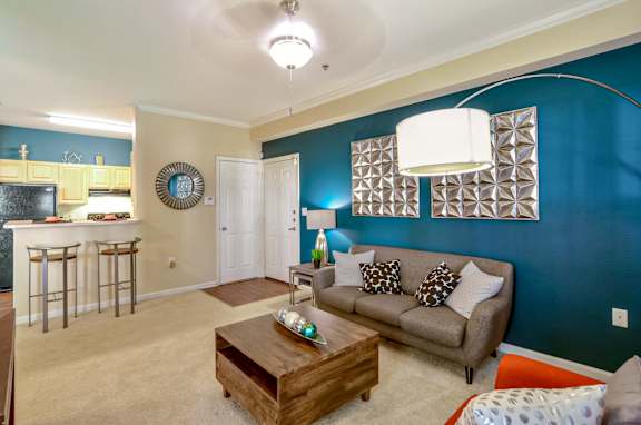 A living room with a brown couch and a wooden coffee table.