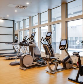 a gym full of equipment and mirrors in a luxury gym