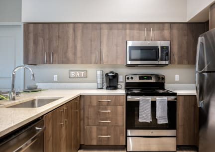 a modern kitchen with a large island and stainless steel appliances