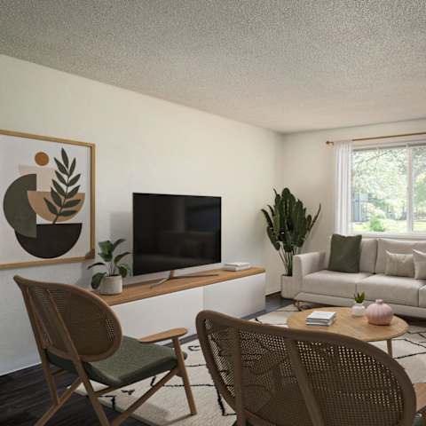A living room with a television, couch, and chairs.
