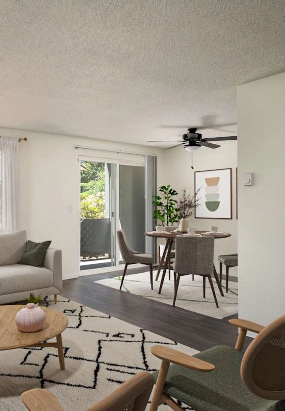 A living room with a couch, a chair, a table, and a ceiling fan.
