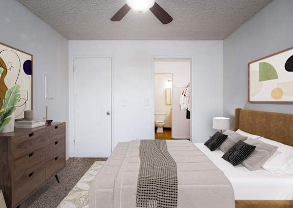A bedroom with a bed, dresser, and ceiling fan.