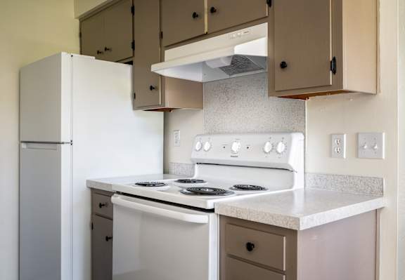 A white stove with a white oven in a kitchen.