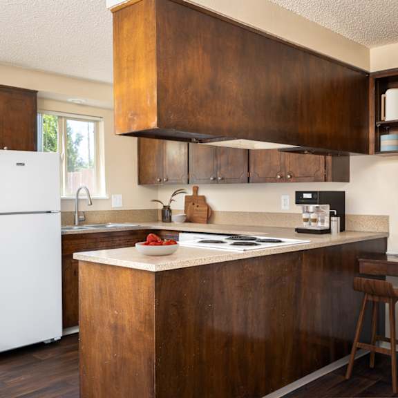 a kitchen with wooden cabinets and a white refrigerator