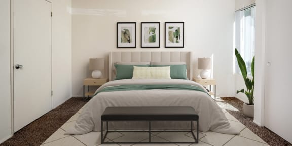 a bedroom with white walls and a bed with green pillows