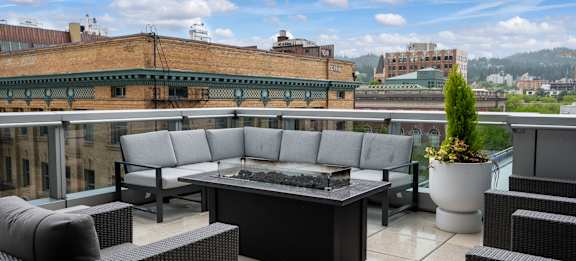 a terrace with couches and a table on a balcony