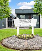 A sign for Briar Creek Apartments is surrounded by flowers.