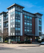 a view of the front of the building with a white car parked in front of it