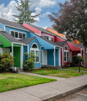 a row of colorful houses in a suburban neighborhood