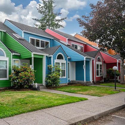 a row of colorful houses in a suburban neighborhood