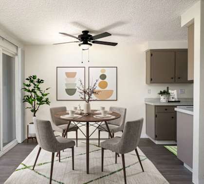 A dining room with a table set for four.