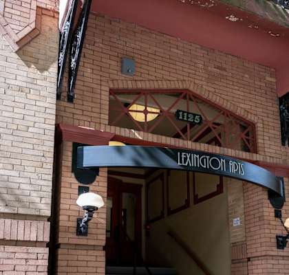 the front of a brick building with an entrance sign