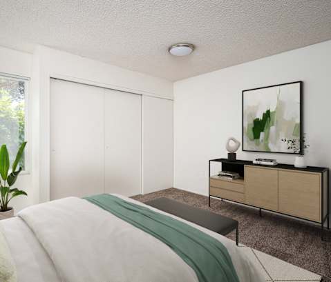 a bedroom with a bed and a large window