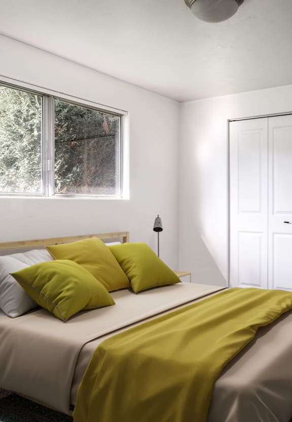 a bedroom with two closets and a window