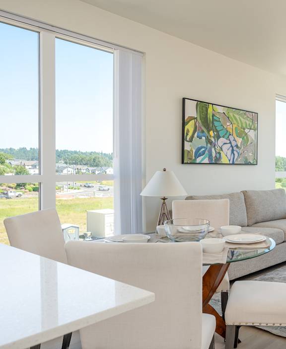 A modern living room with a dining table and chairs.