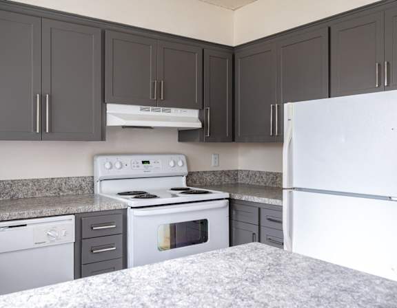 an empty kitchen with granite counter tops and stainless steel appliances