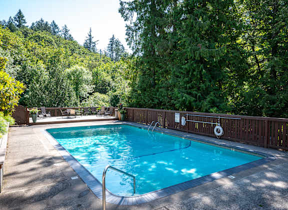 Swimming Pool With Relaxing Sundecks by a wooden fence and trees at Timberlee, Portland, OR, Oregon , 97221