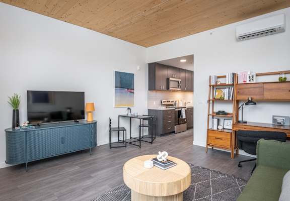 a living room with a couch and a table and a television