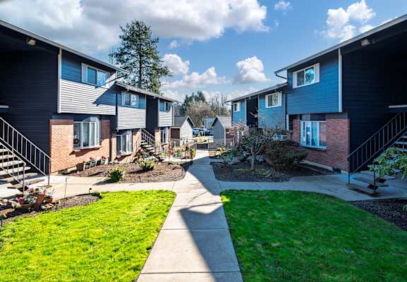 A sunny day at a residential area with houses and green lawns.