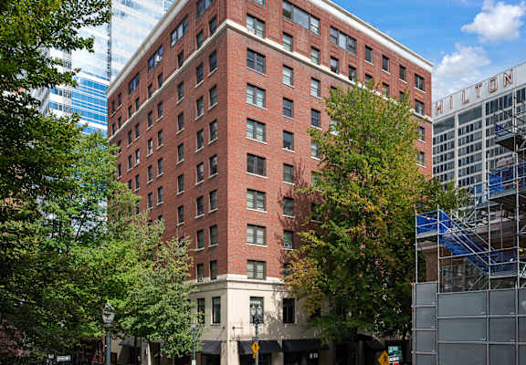 a tall brick building on a city street